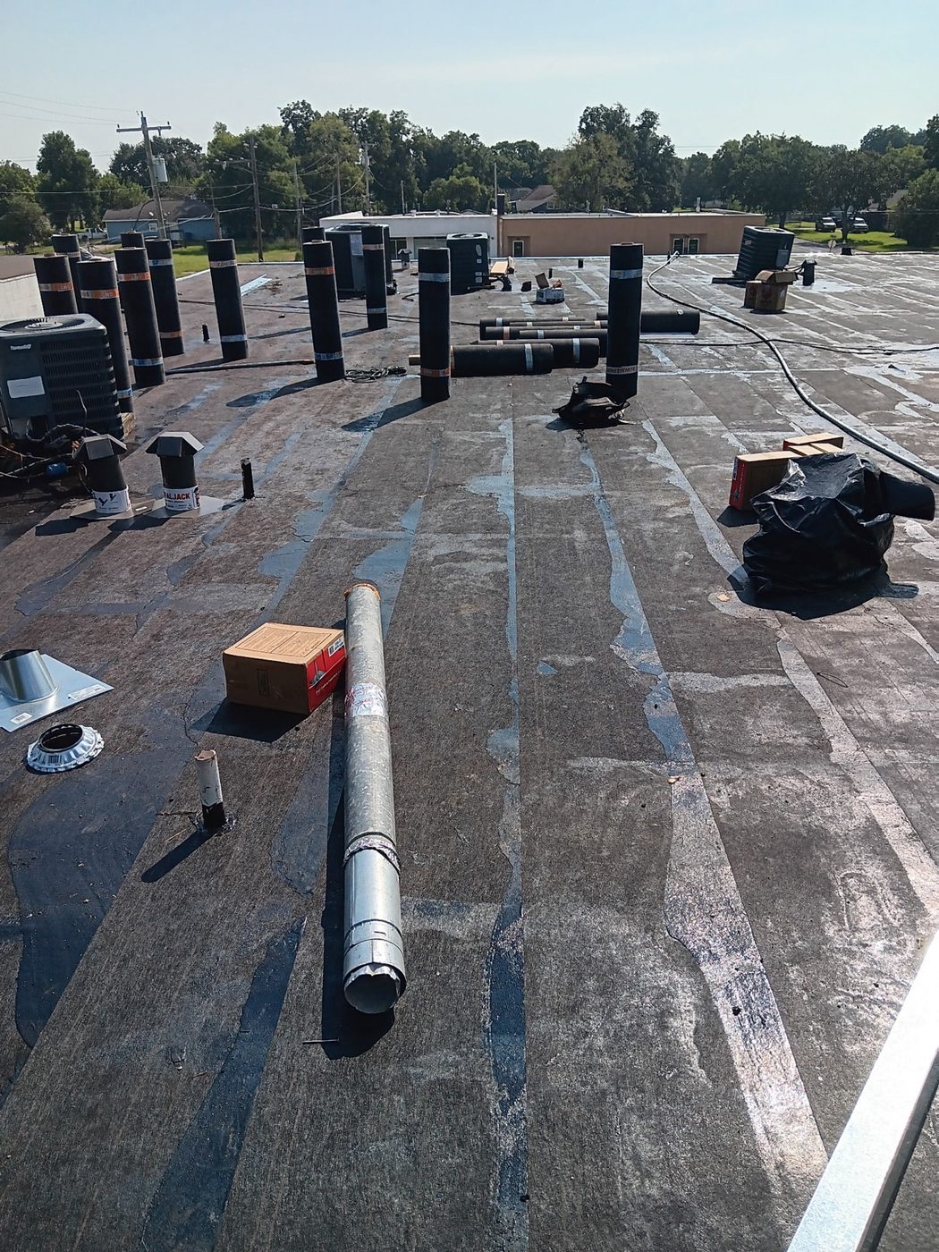 Commercial flat roof with modified bitumen roofing and rooftop equipment