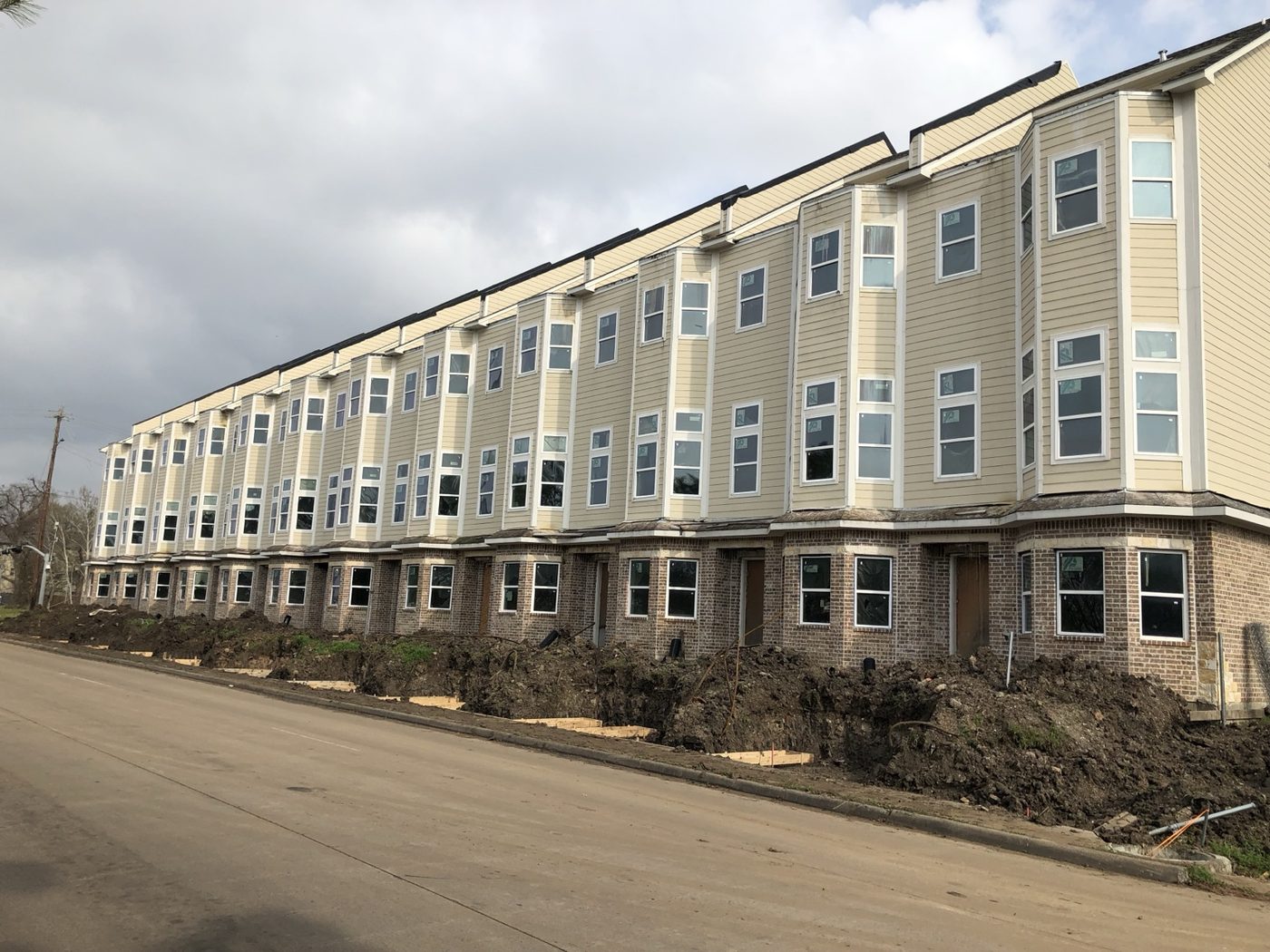Row of townhomes with brick and siding exteriors